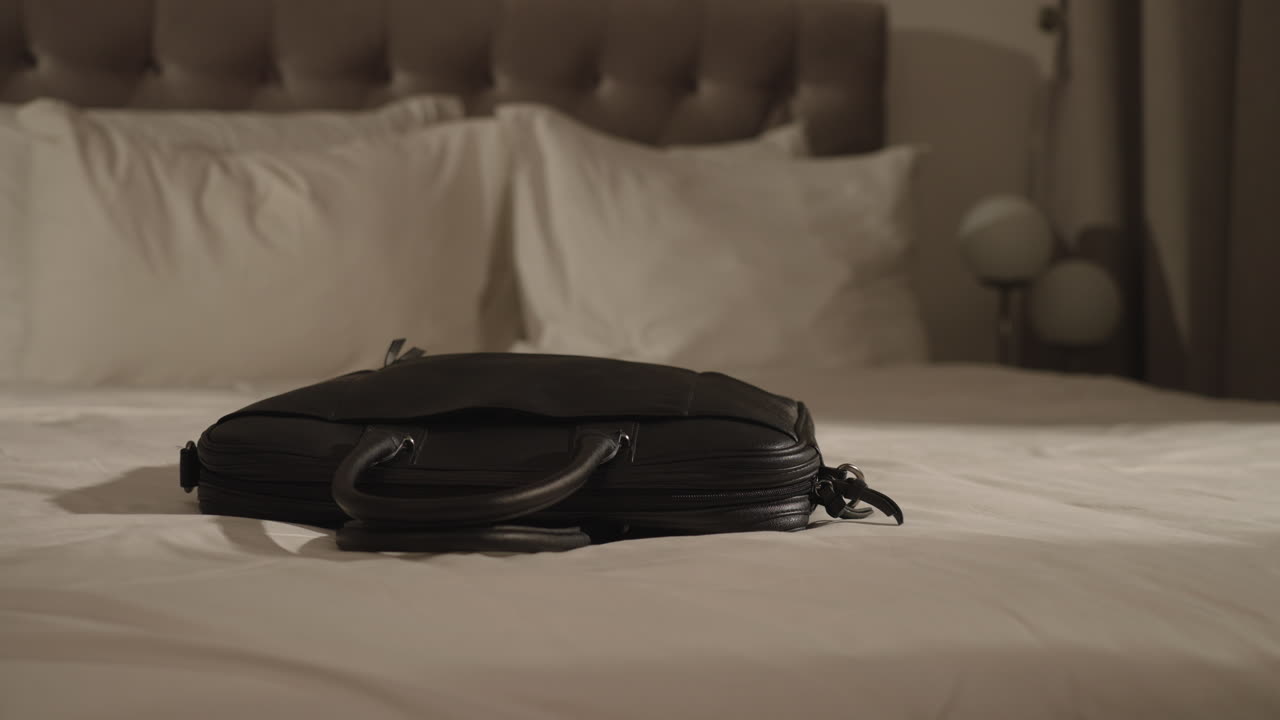 Businessman Takes Laptop In A Bag From Bed. closeup
