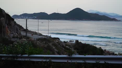 static wide shot of crashing waves from pacific ocean during dusk in vietnam