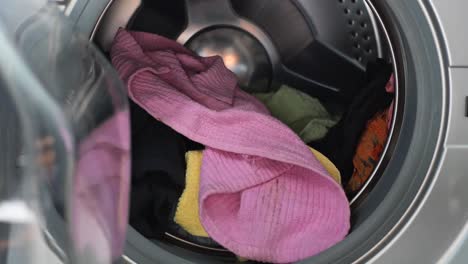 Putting-towel-and-cloths-in-a-washing-machine
