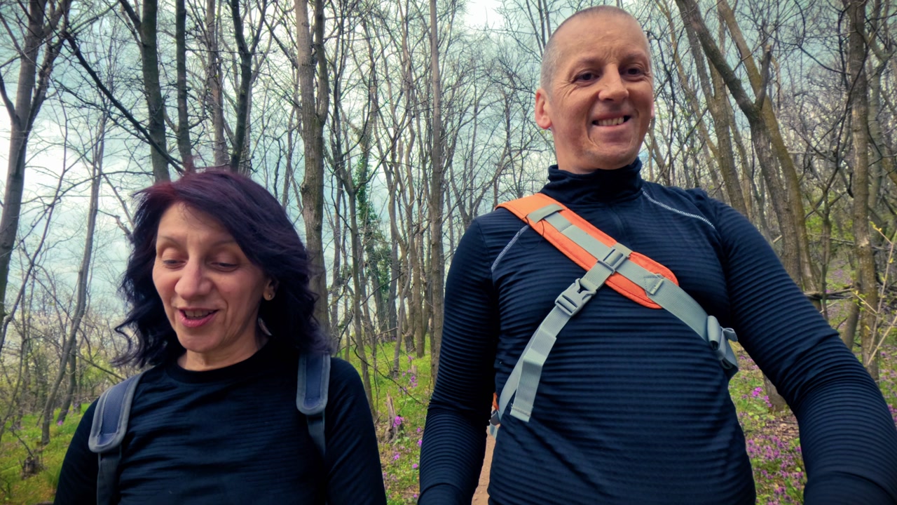 Travelers with backpacks walking through a scenic woodland path. Highlighting local tourism, weekend getaways, sightseeing, and outdoor exploration.