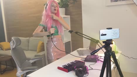 woman singing and recording music in a home studio