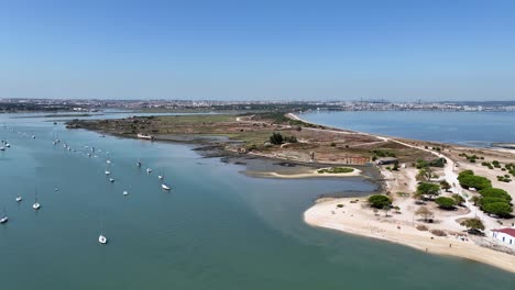 drone shot flying in over field on small island from the water