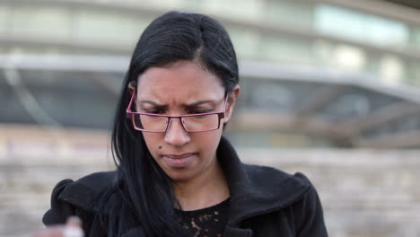 thoughtful hindu businesswoman in eyeglasses with tablet