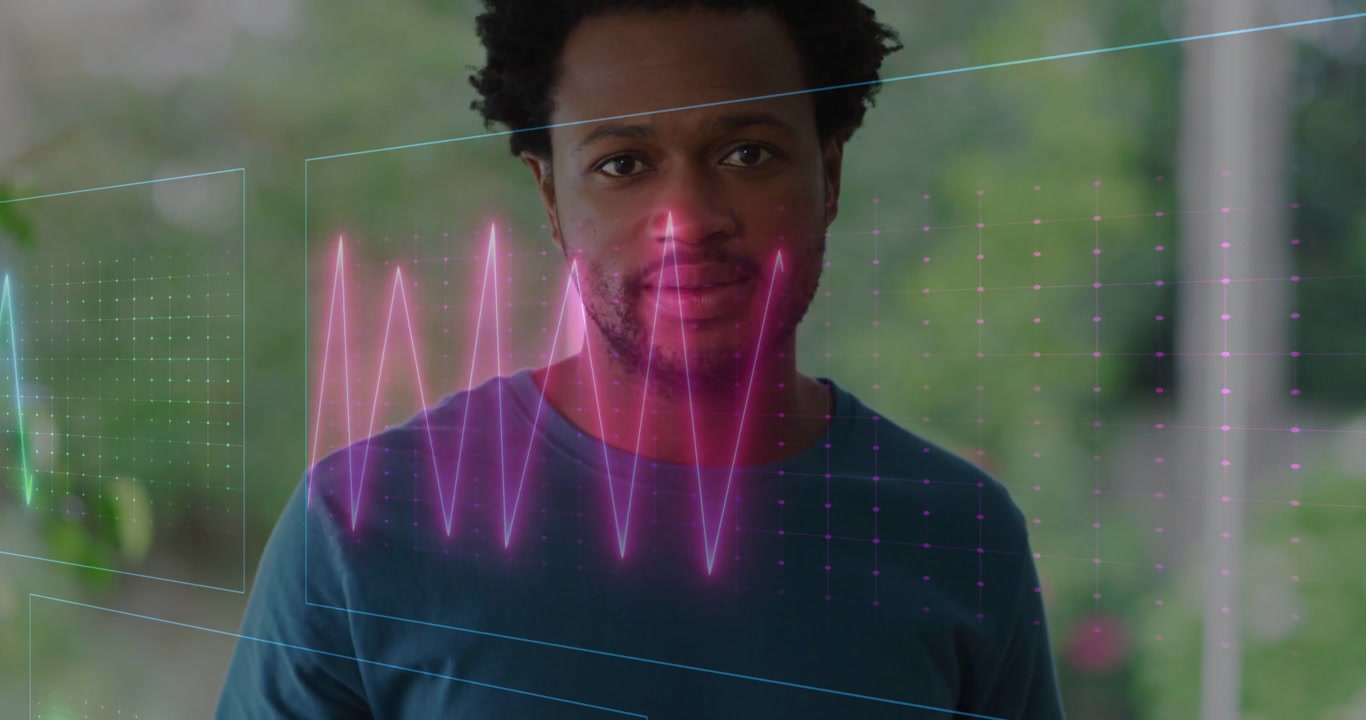Vertical video: Facing man in teal longsleeve shirt watching ECG holograms appearing on porch