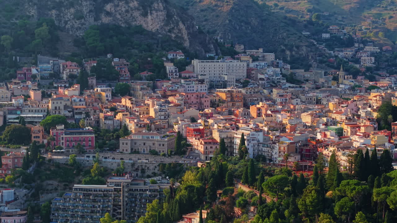 Scenic aerial view of Taormina, Sicily, vibrant urban landscape, sunset