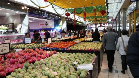 shoppers browse vibrant fruit and vegetable stalls