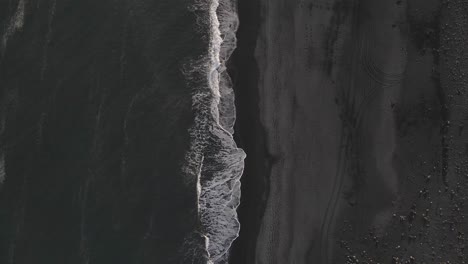 waves crashing on black sand beach in iceland