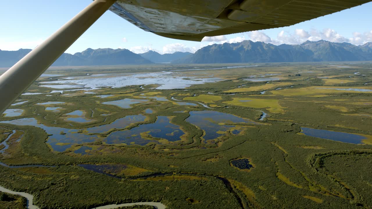 Alaskan Tundra Wetlands, Aerial View From Small Airplane Flying Above Landscape. Passenger Point of View