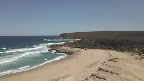 Aerial-view-over-a-beautiful-wide-sandy-beach