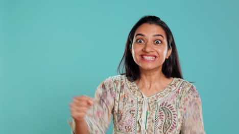 Portrait-of-joyful-woman-celebrating,-showing-positive-emotions,