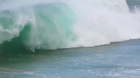 dynamic ocean waves crash against the shore at port campbell, australia. captured in bright daylight, showcasing the sea's raw power