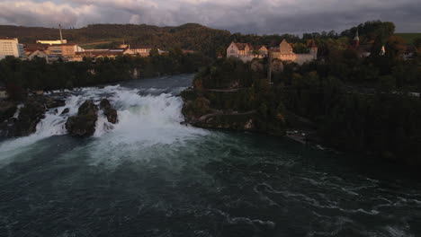 aerial shot in orbit over the falls of the rhine and where the castle of laufen can be seen