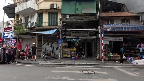 busy street scene with pedestrians and motorbikes