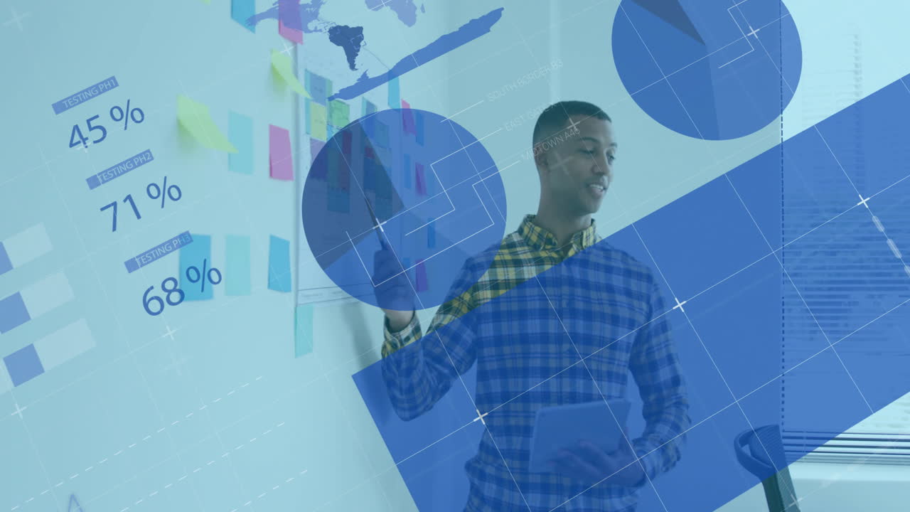 Man writing on glass board in business office, with sticky notes and network overlays showing data