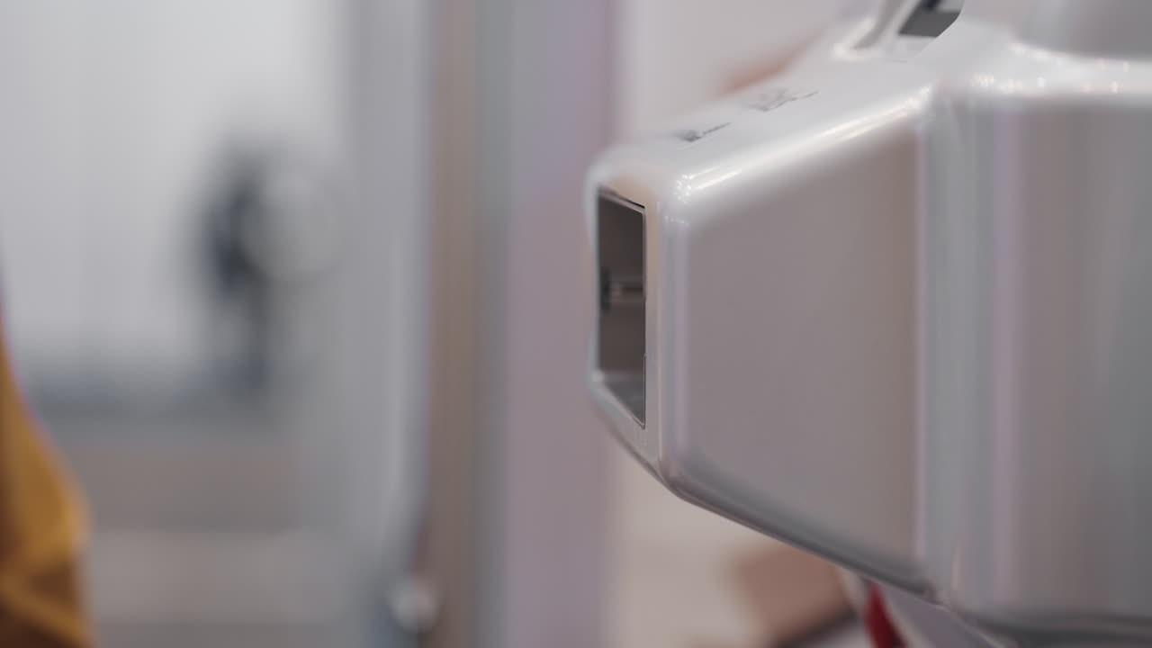 Person feeding crumpled packing paper into a machine
