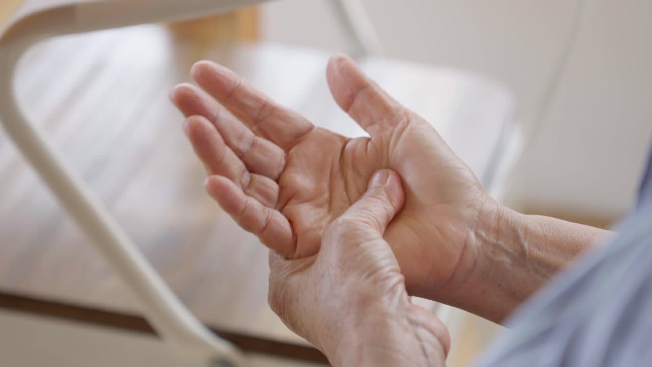 Close up of old woman hands massaging on her palm