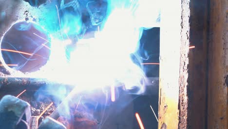 ultra close shot of a worker welding metal on a window frame