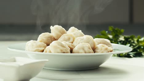 steaming pierogi in a white bowl