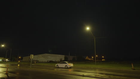 lightning flashing over road as car passes slow motion rain