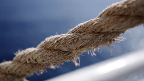 close up gimbal shot of ferry rope, bright ocean in background