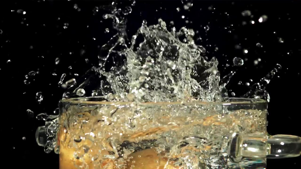 Fresh Potatoes Splashing into Water in a Glass Pot