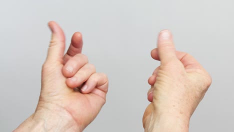 a close up view of two hands snapping isolated in front of a white background