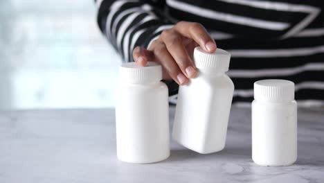 person handling medicine bottles