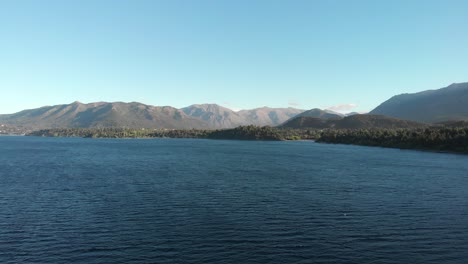 Luftschwenk-über-Den-Tiefblauen-See-Nahuel-Huapi-Und-Die-Dahinter-Liegenden-Berge