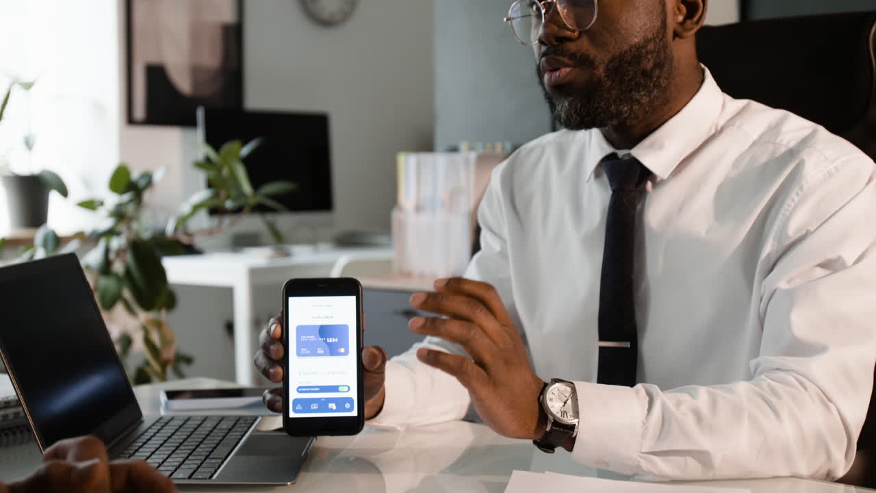 Man using smartphone for credit card payment in office setting