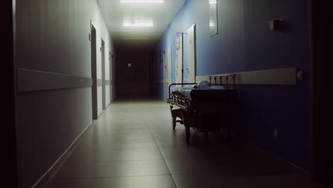 empty hospital corridor at night with stretcher