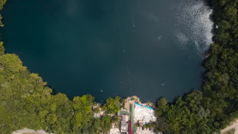 bird's eye view top down drone shot of the famous cenote azul located in bacalar, mexico shot in 4k