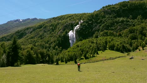 man performs trekking in mountains with beautiful waterfalls in the background