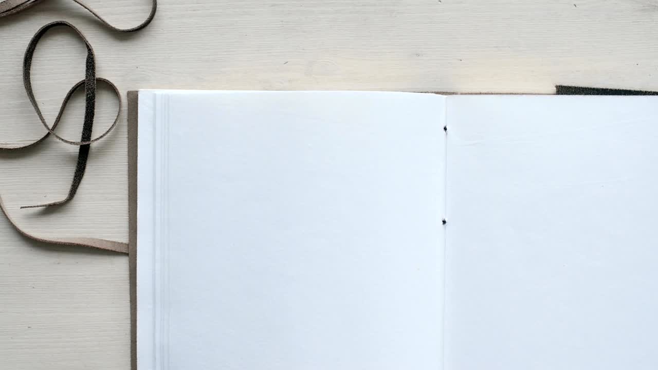 Mans hands open handmade a4 notebook with real leather cover