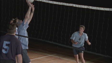 men's teams play a game of volleyball