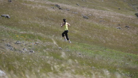 a young woman runs up a hillside