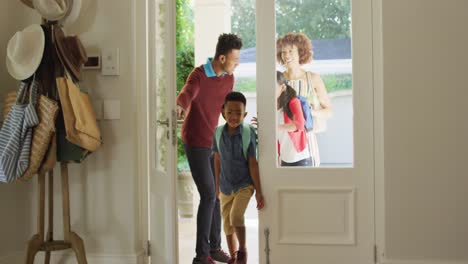 happy african american family entering the house from front door