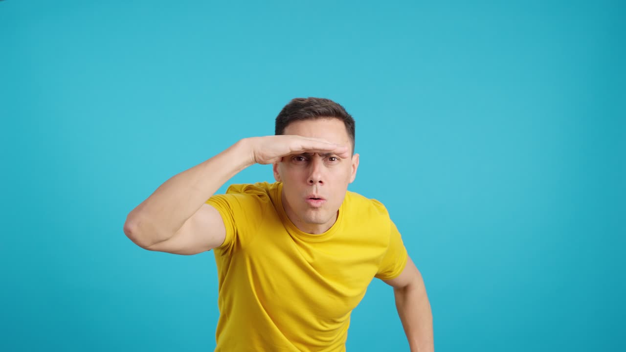 Man in yellow t-shirt looking and searching