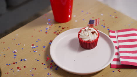 close up of cupcakes with american stars and stripes flags and bottles of beer at party celebrating 4th july independence day 4