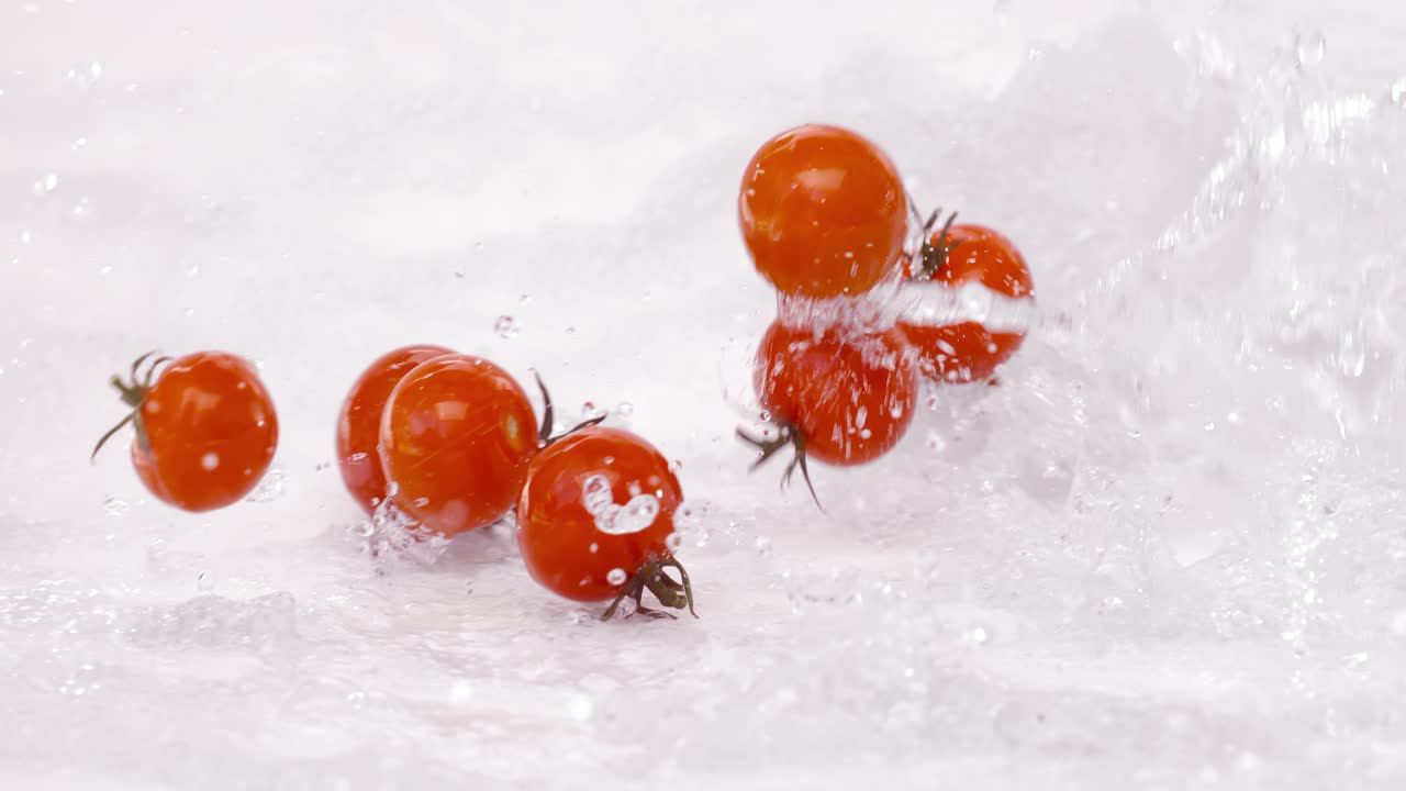 Fresh water splash on red Cherry tomatos. Shot on super slow motion camera 1000 fps