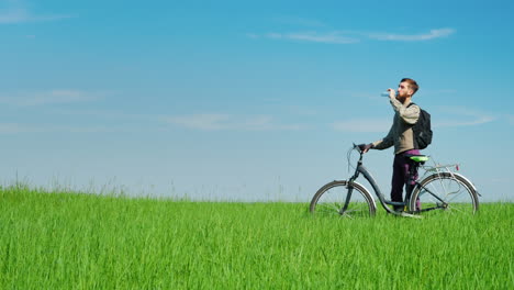 a young cyclist drinks water