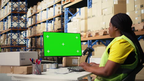 vertical video black female worker manages orders next to green screen display