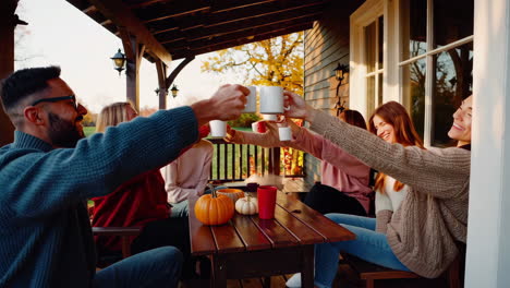 friends enjoying an autumn gathering and toast on a cozy porch