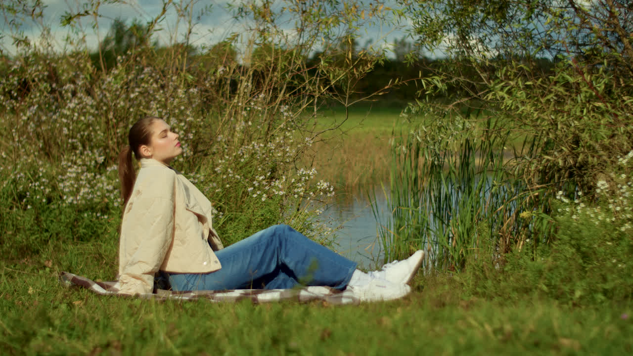 Woman relaxing by a lake in nature