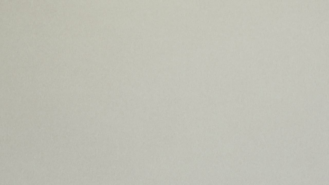 Blue crumpled paper unfolds on grey in a stop motion transition