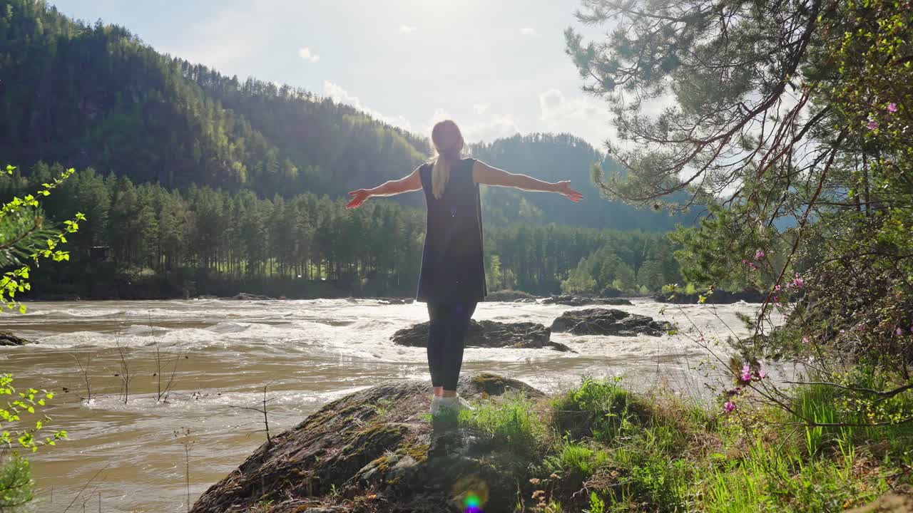 Woman enjoying the scenic beauty of a mountain river