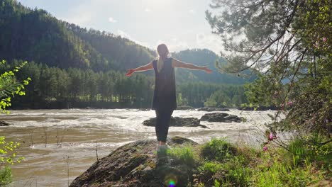 woman enjoying the scenic beauty of a mountain river