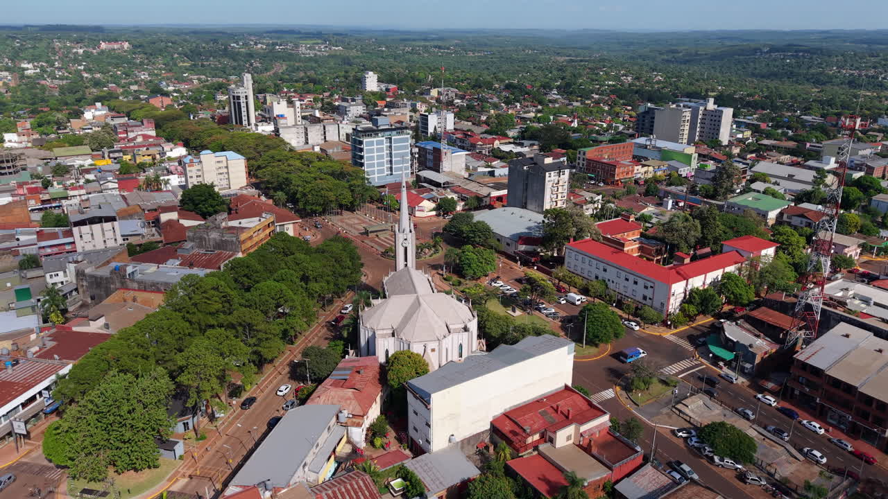 Wide-angle rotating drone shot over San Antonio Cathedral and surrounding buildings. Distant horizon and vegetation in and around city. Shot on 4K at 60fps