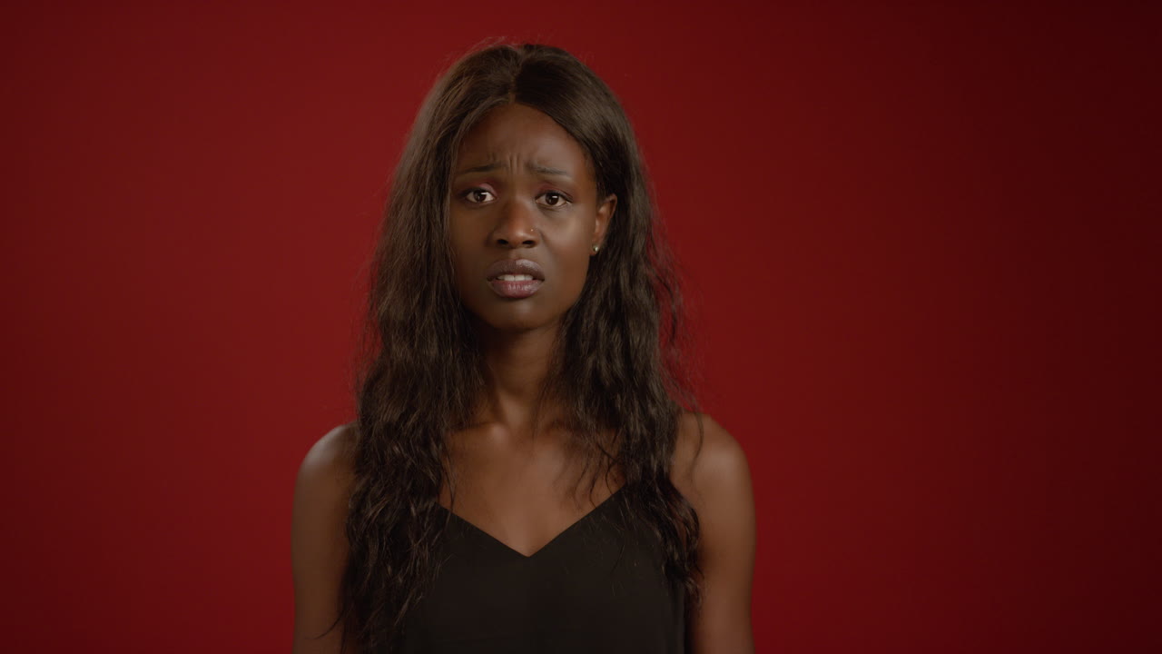 Sad Young Woman Looks at Camera