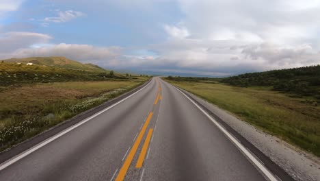 driving a car on a road in norway at dawn