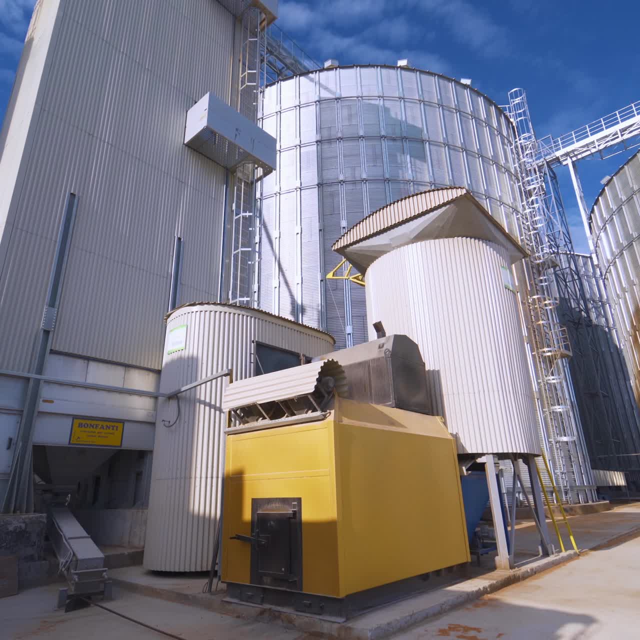 Plant for processing and silos for drying cleaning and storage of agricultural products, flour, cereals and grain. Silver tanks close-up